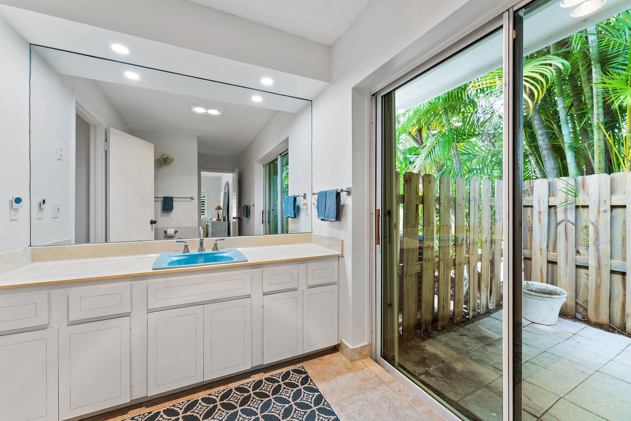 80 Southeast Turtle Creek Drive Jupiter, FL 33469 - Photo 15 of 23 a bathroom with a double vanity sink and mirror