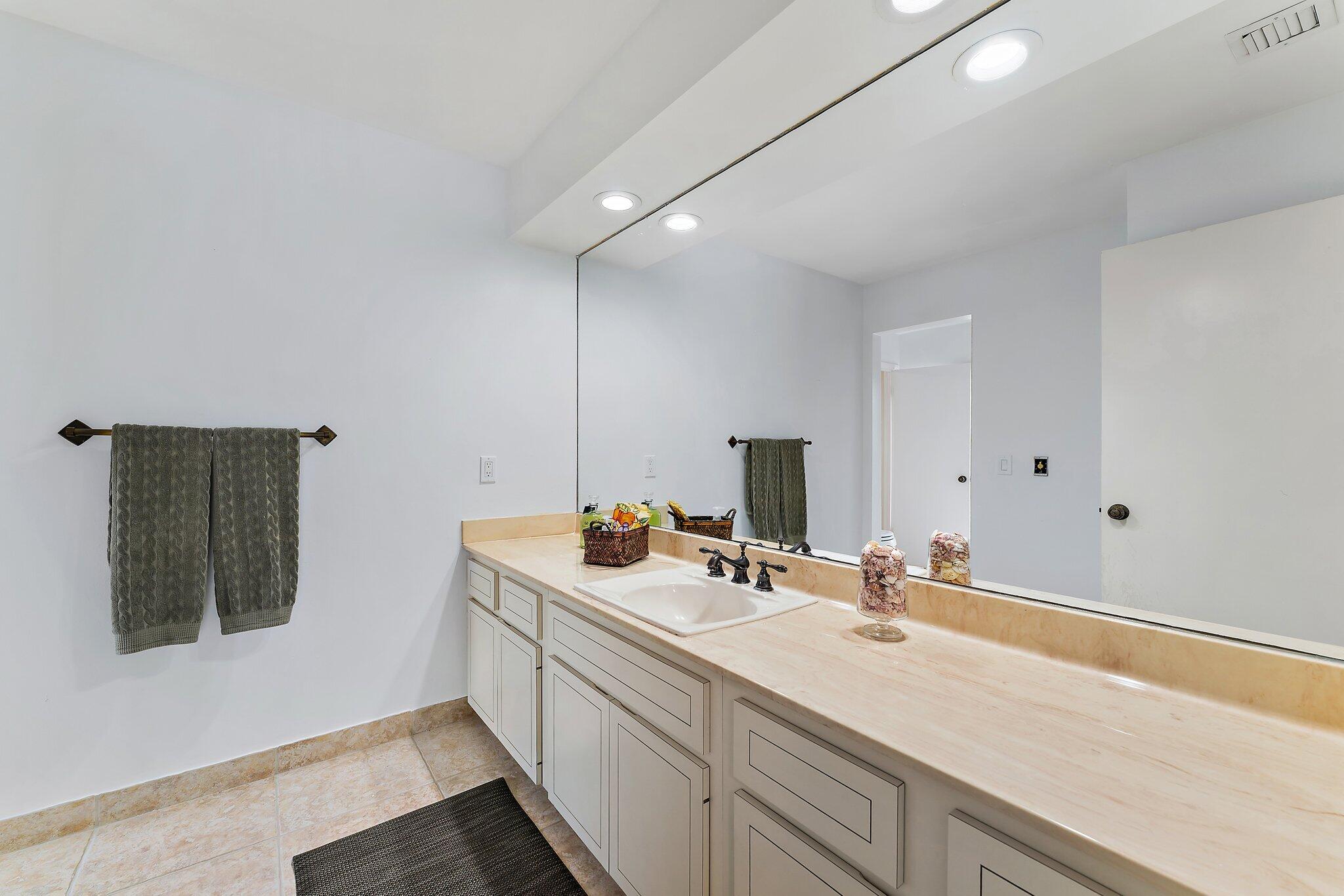 80 Southeast Turtle Creek Drive Jupiter, FL 33469 - Photo 17 of 23 a bathroom with a sink and a mirror