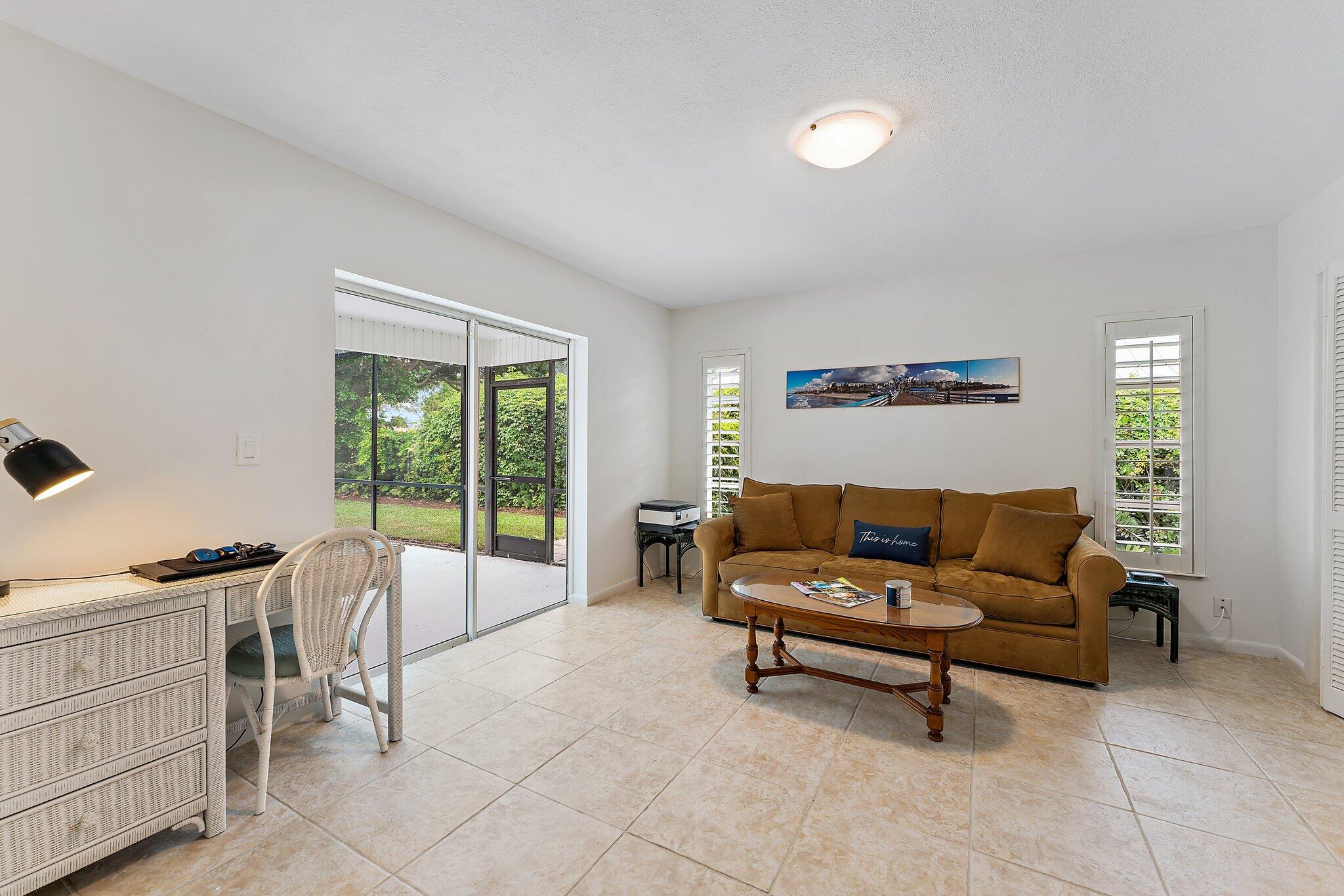 80 Southeast Turtle Creek Drive Jupiter, FL 33469 - Photo 18 of 23 a living room with furniture and a dresser next to a window
