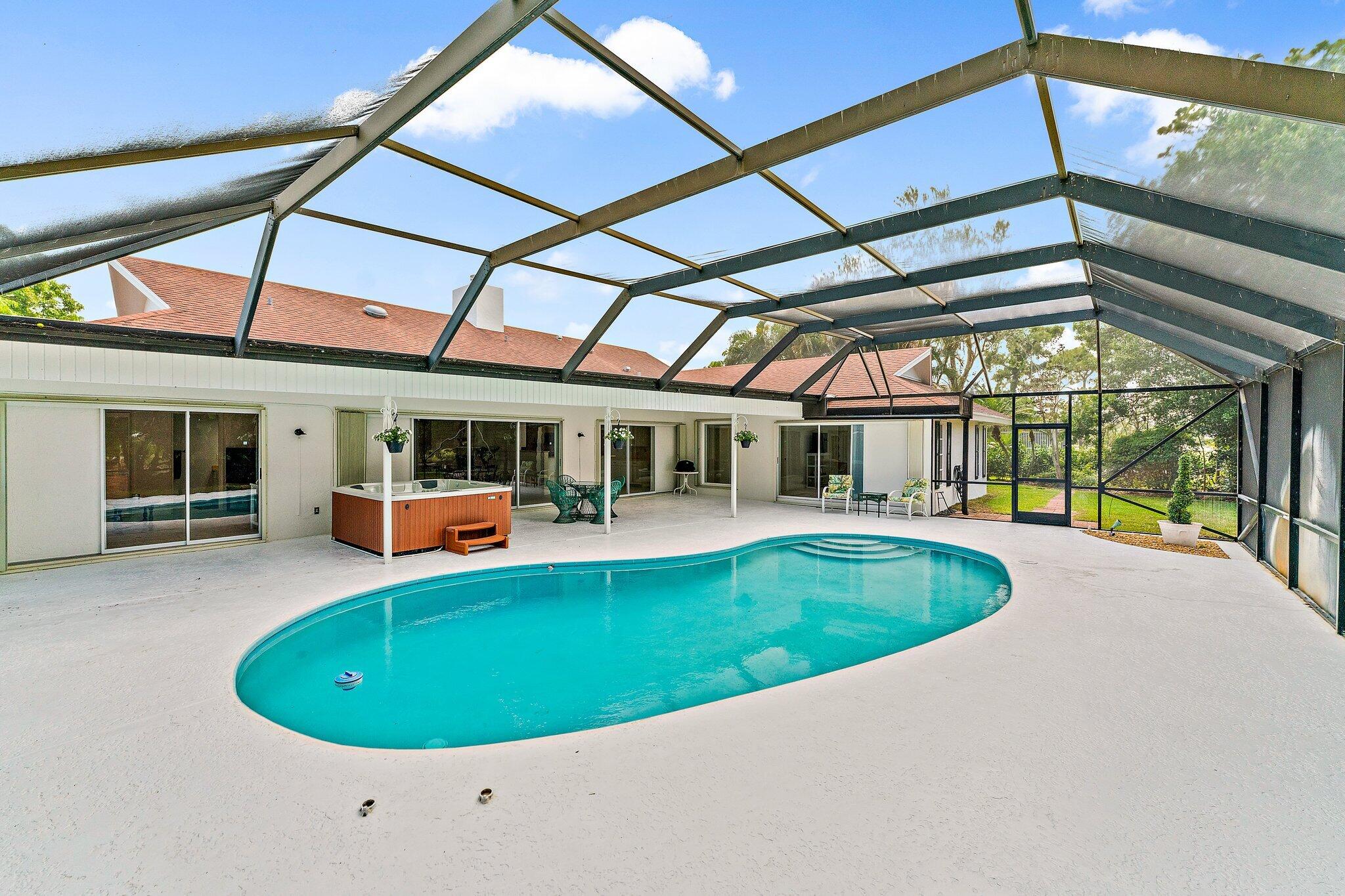 80 Southeast Turtle Creek Drive Jupiter, FL 33469 - Photo 20 of 23 a view of a house with a swimming pool