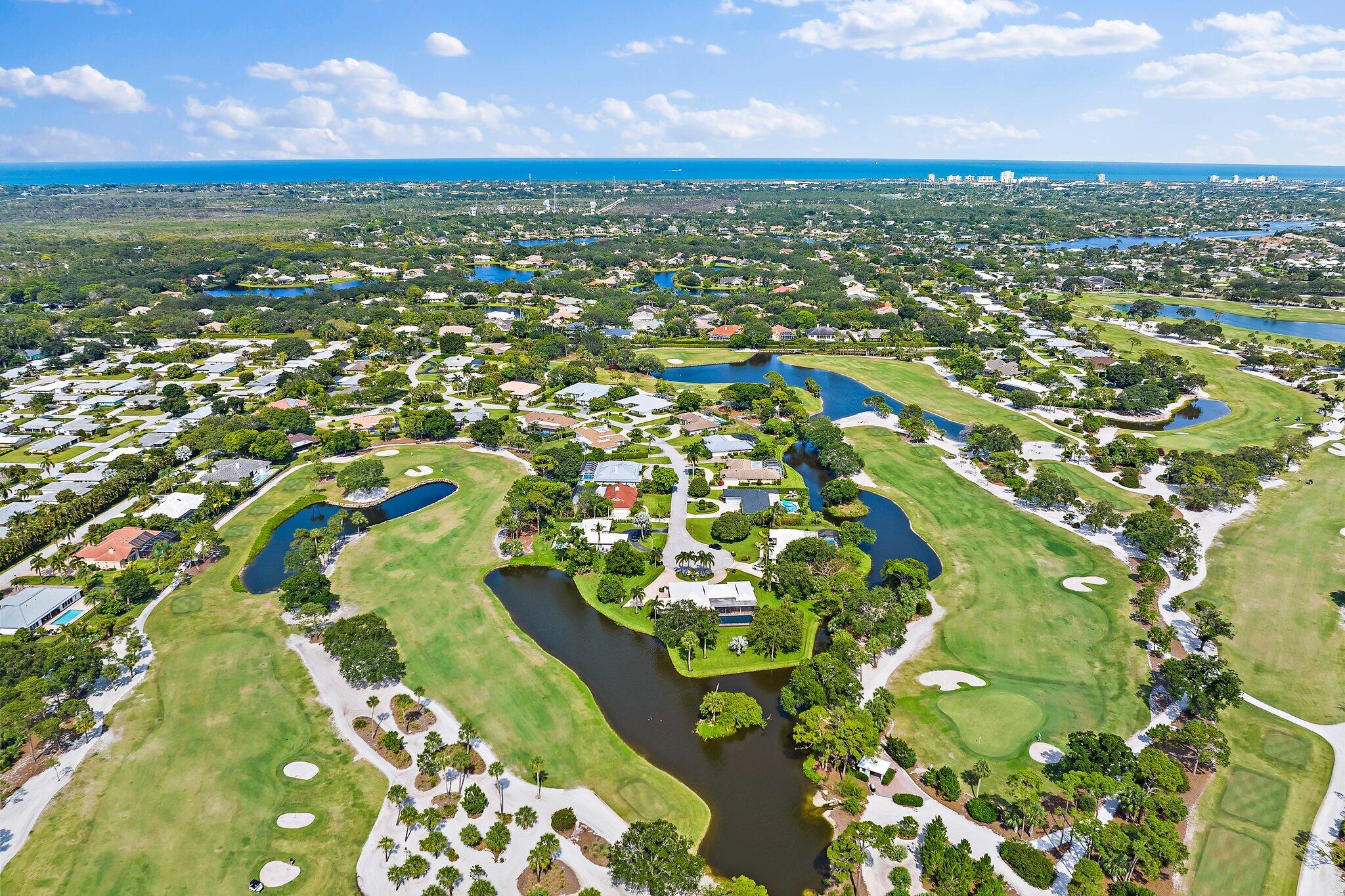 80 Southeast Turtle Creek Drive Jupiter, FL 33469 - Photo 3 of 23 an aerial view of residential houses with outdoor space and trees
