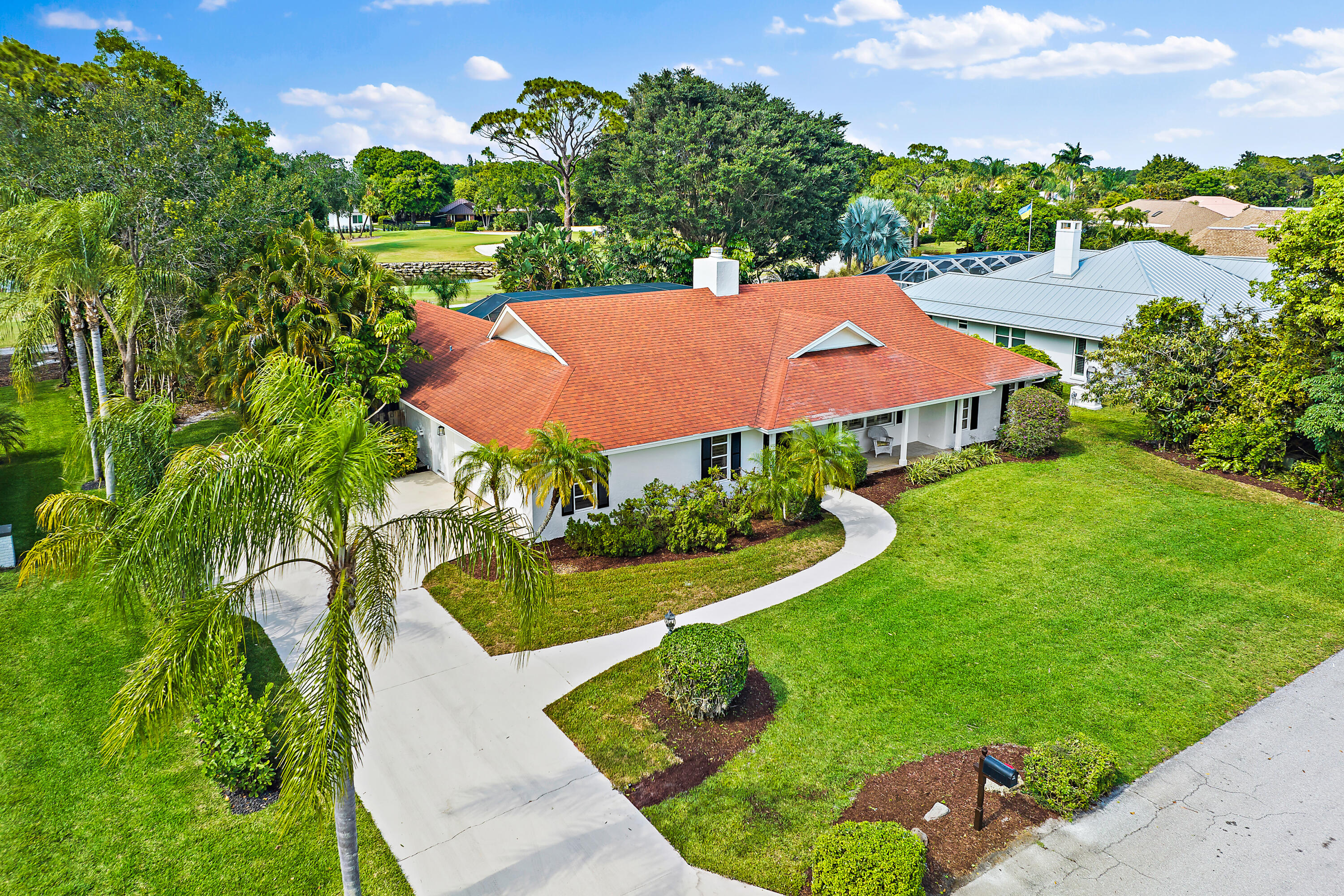 80 Southeast Turtle Creek Drive Jupiter, FL 33469 - Photo 5 of 23 an aerial view of a house with garden space and street view