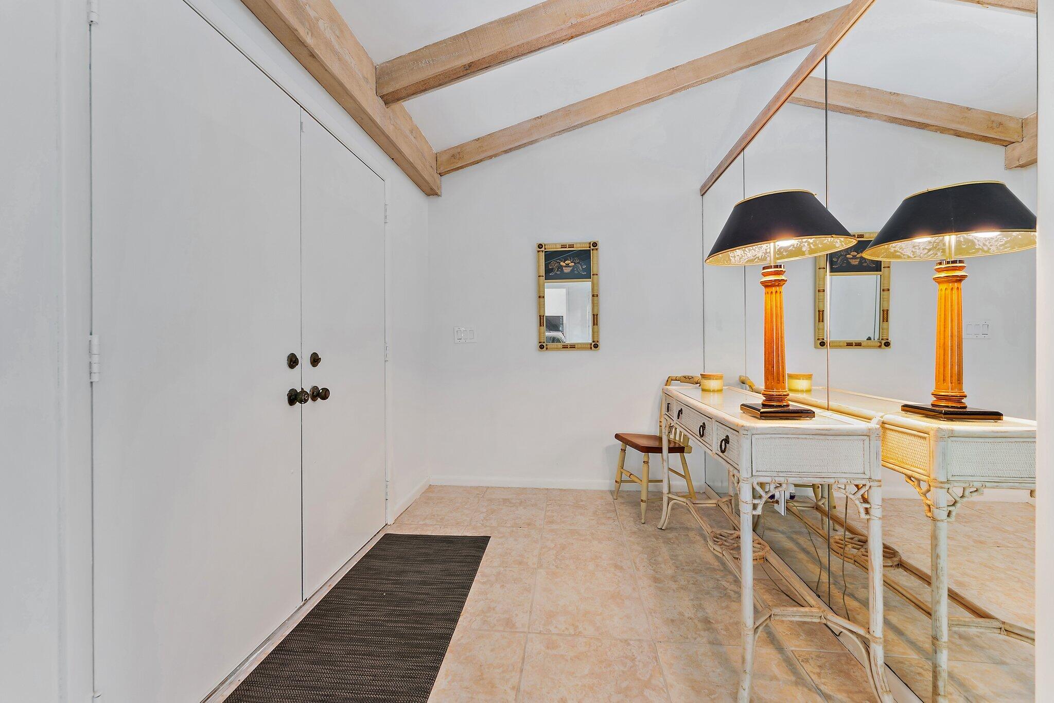 80 Southeast Turtle Creek Drive Jupiter, FL 33469 - Photo 8 of 23 a dining room with furniture and a rug