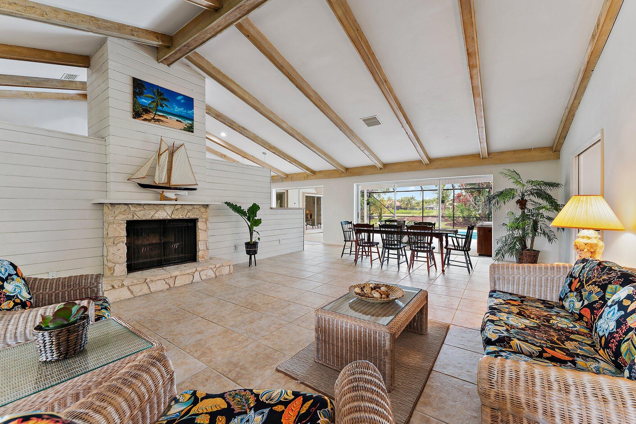 80 Southeast Turtle Creek Drive Jupiter, FL 33469 - Photo 9 of 23 a living room with furniture and a fireplace