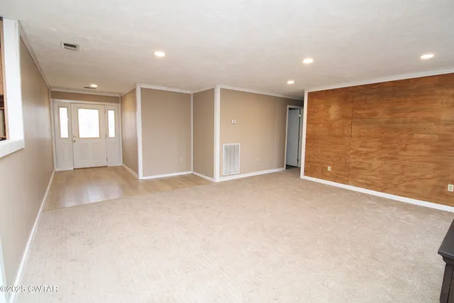 a view of an empty room with a window