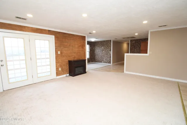 an empty room with windows and closet