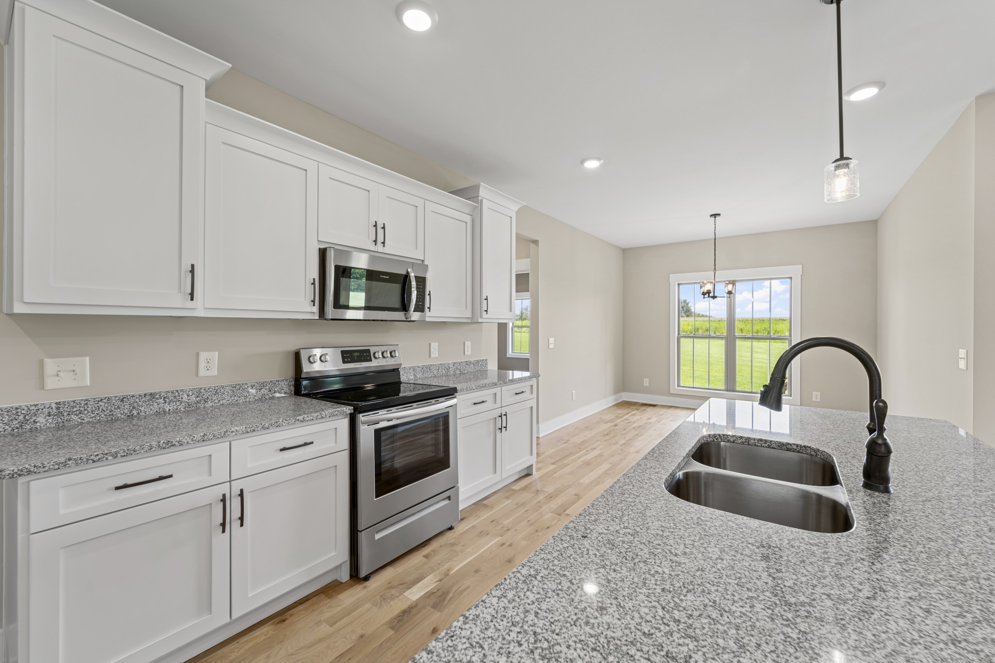 537 Clearview Road Cottontown, TN 37048 - Photo 3 of 15 a kitchen with granite countertop a sink stainless steel appliances and white cabinets