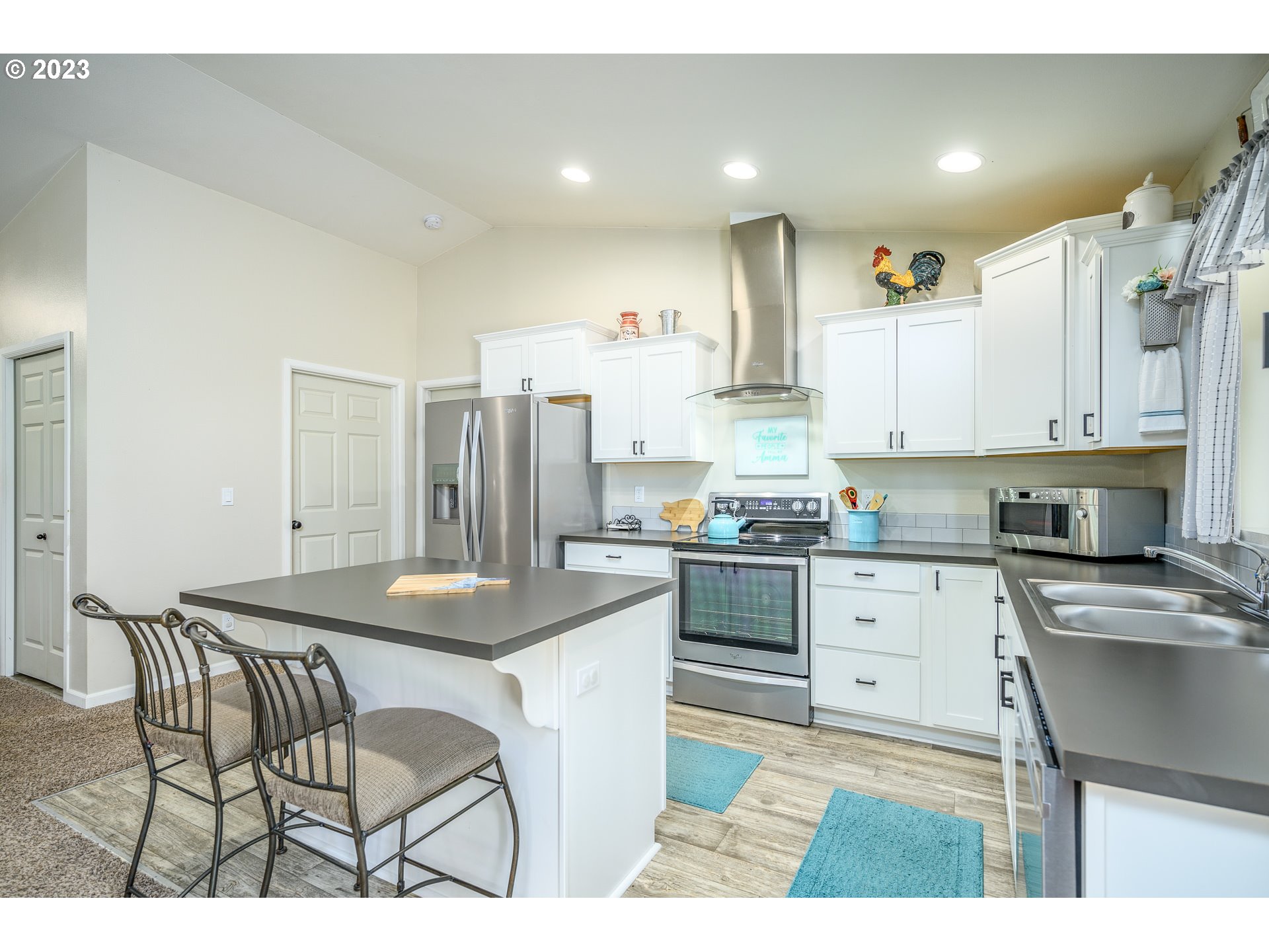 7297 Ash Street Grand Ronde, OR 97347 - Photo 13 of 33 a kitchen with stainless steel appliances kitchen island granite countertop a sink and cabinets