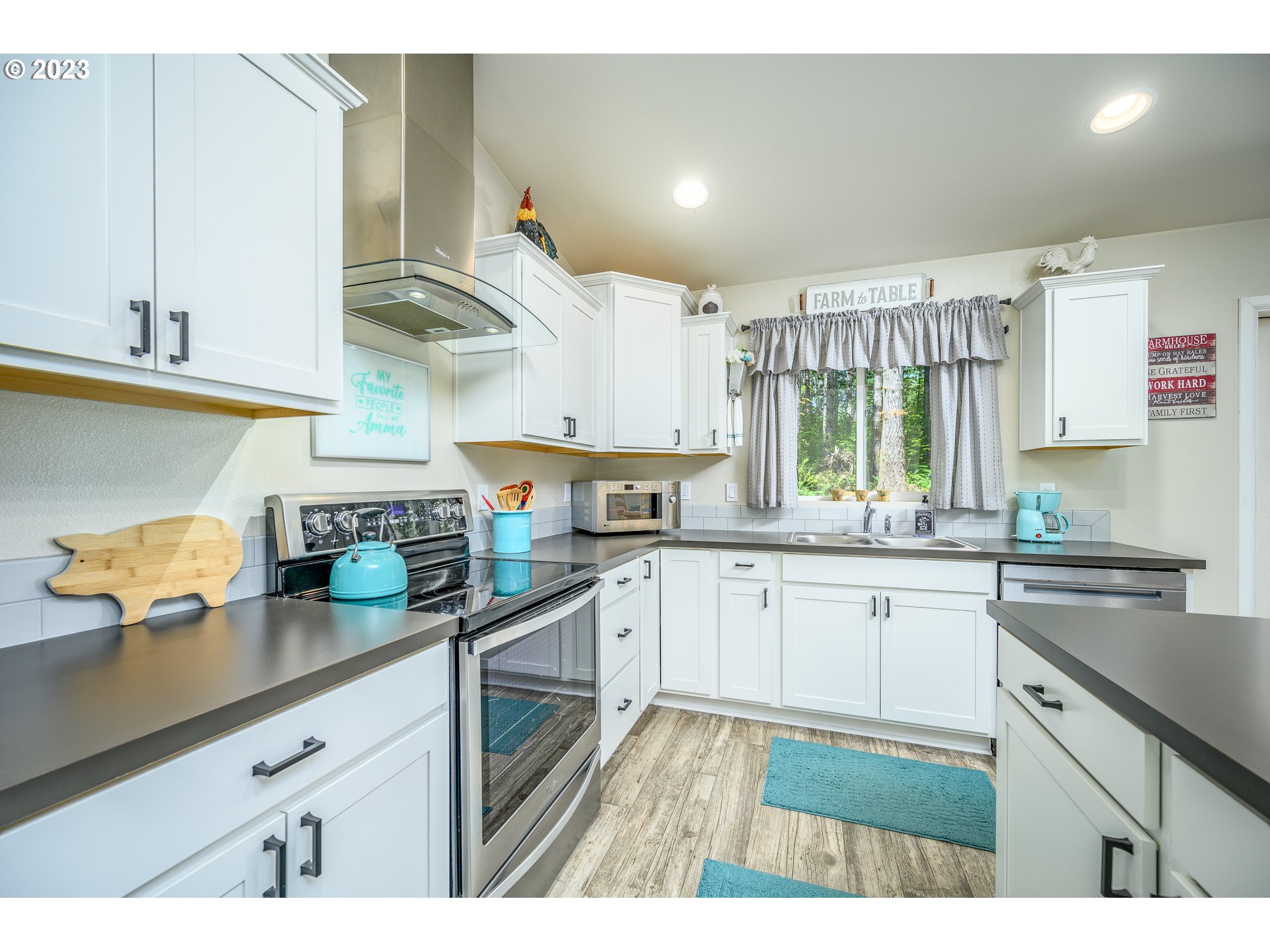 7297 Ash Street Grand Ronde, OR 97347 - Photo 14 of 33 a kitchen with stainless steel appliances granite countertop a sink dishwasher stove and cabinets