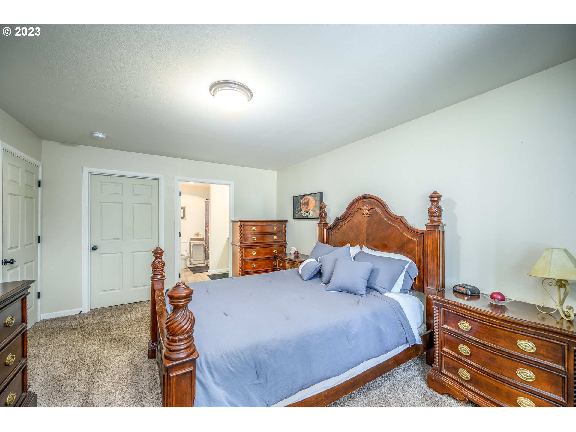 7297 Ash Street Grand Ronde, OR 97347 - Photo 16 of 33 a bedroom with a bed and a painting on the wall
