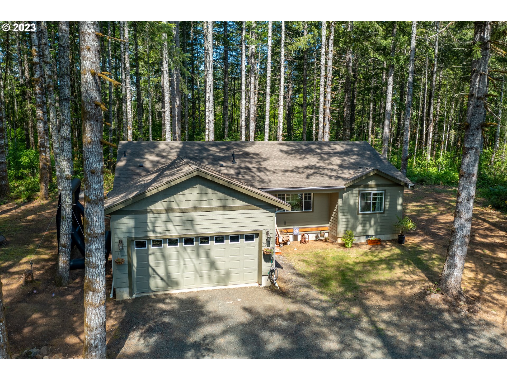 7297 Ash Street Grand Ronde, OR 97347 - Photo 26 of 33 a view of a backyard with a garden and trees