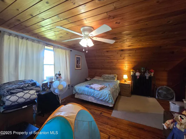 a bedroom with bed and a chandelier