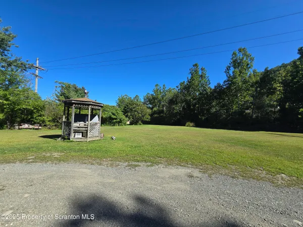 a yellow house with garden in front of it