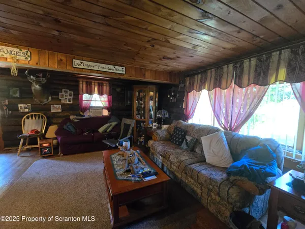 a living room with furniture a window and gym equipment