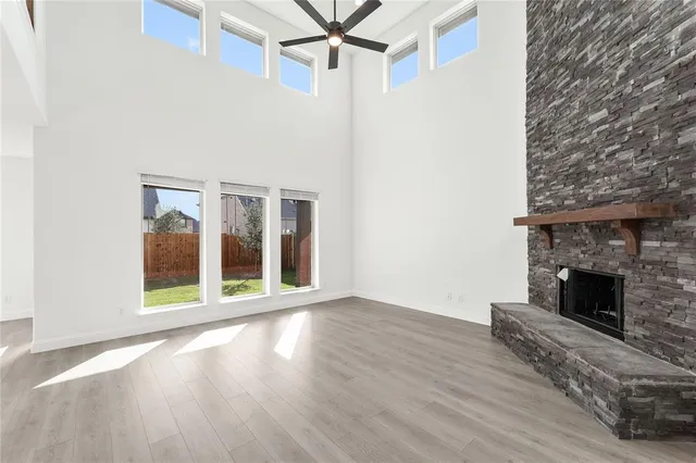 a view of a livingroom with wooden floor and a fireplace