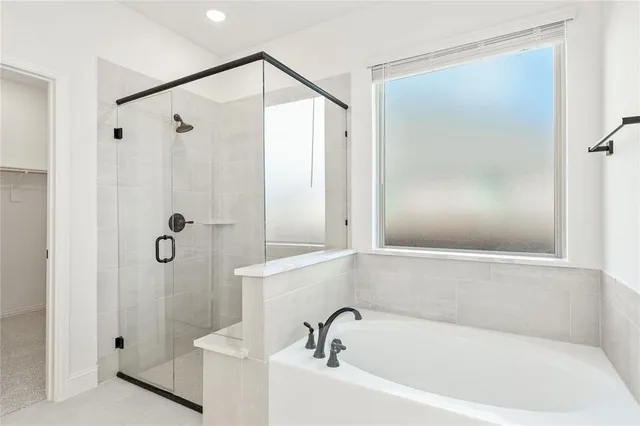a bathroom with a bathtub and shower