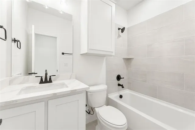 a bathroom with a sink a toilet and a bathtub