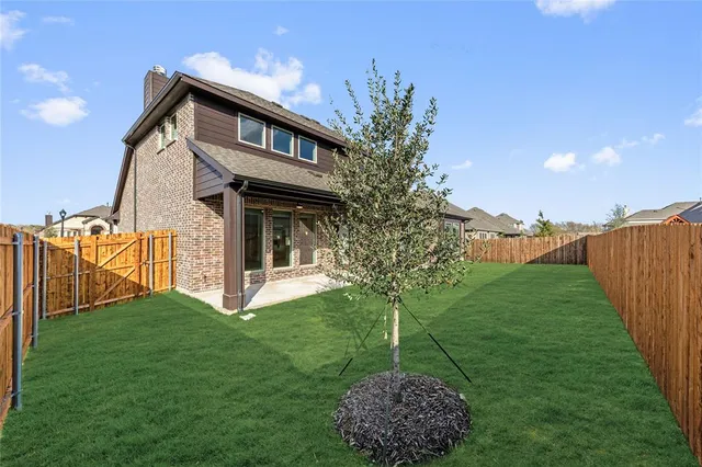 a house with green field in front of it