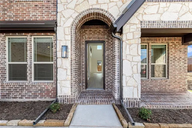 a view of a brick house with large windows