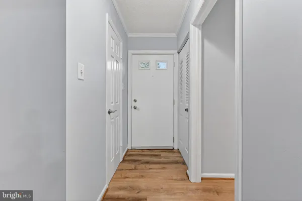 a view of hallway with wooden floor