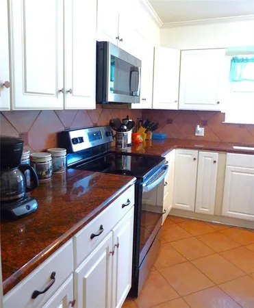 a kitchen with stainless steel appliances granite countertop a sink and cabinets