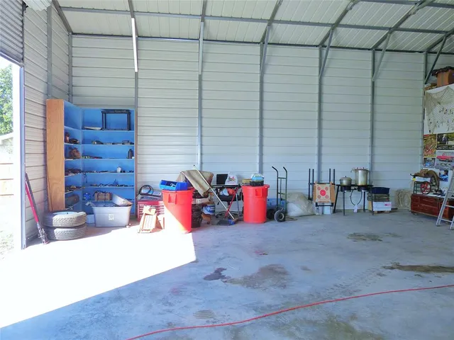 a view of a yard with wooden fence