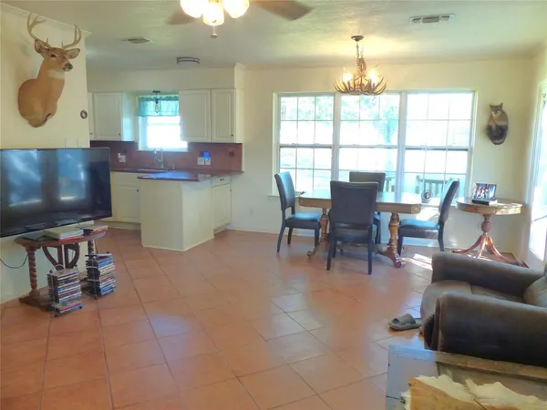 a living room with furniture a window and a flat screen tv