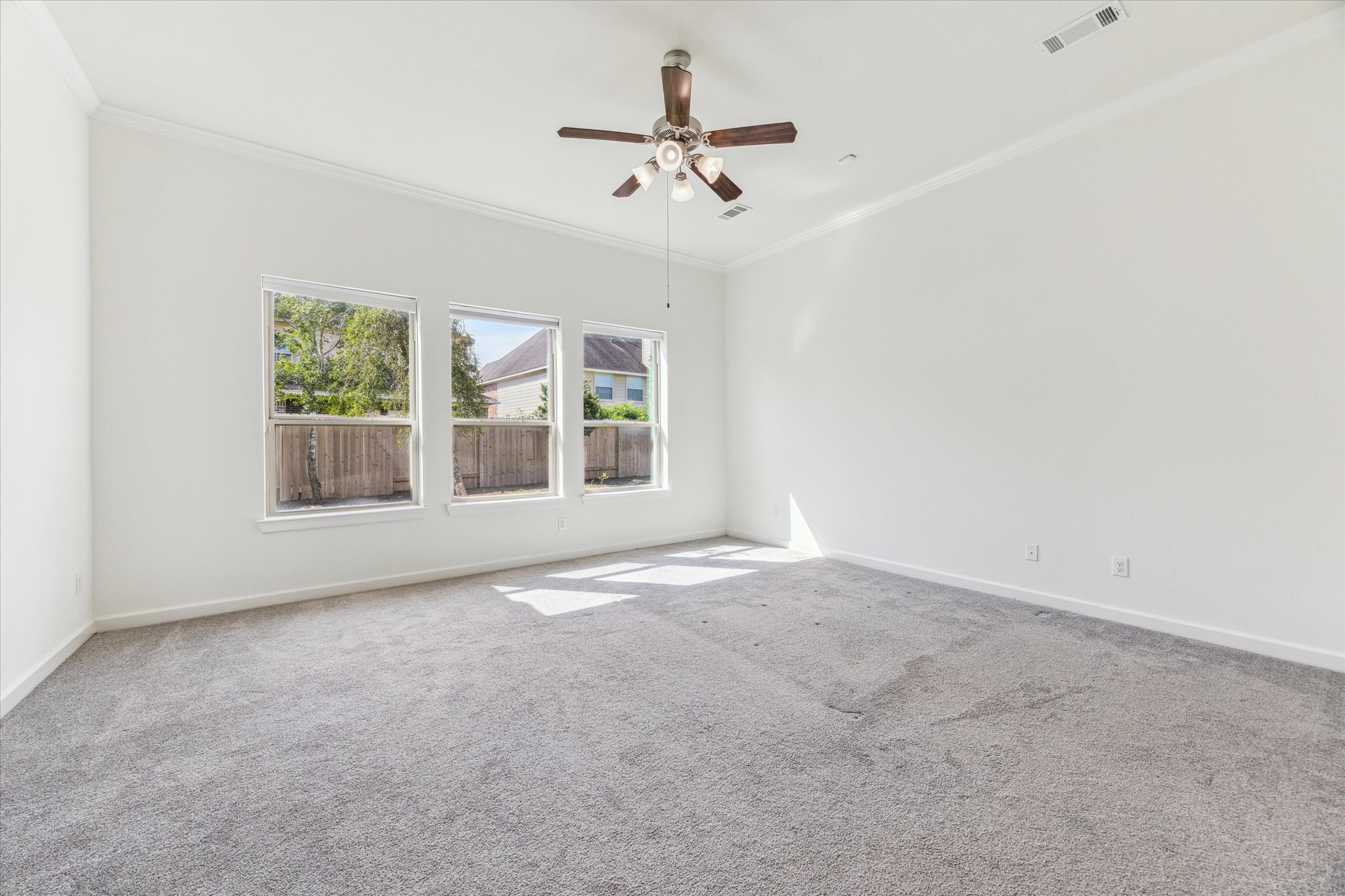 26223 Rustic Ranch Lane Katy, TX 77494 - Photo 12 of 33 an empty room with windows and ceiling fan