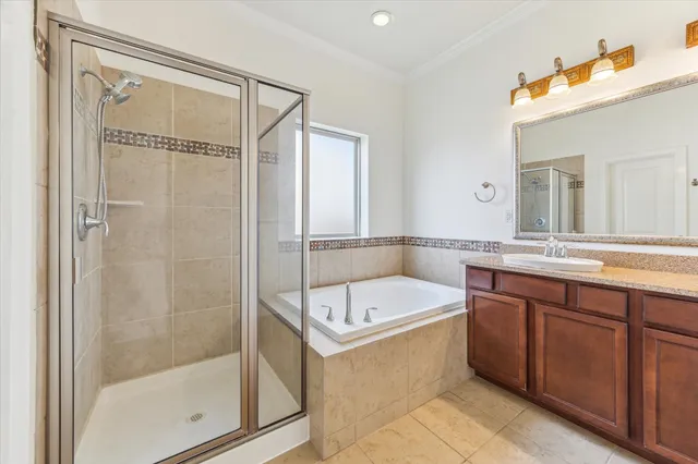 a bathroom with a tub a sink and mirror