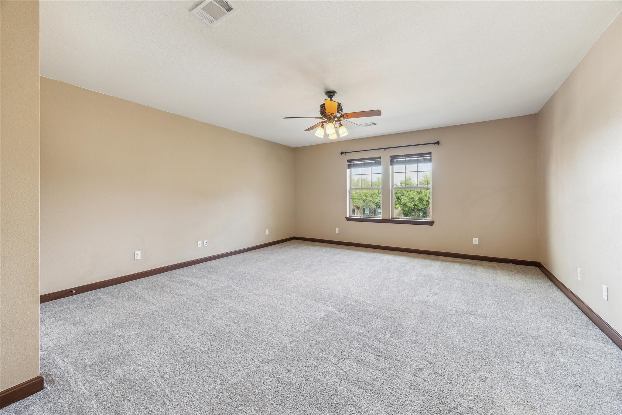 26223 Rustic Ranch Lane Katy, TX 77494 - Photo 16 of 33 an empty room with windows and chandelier fan