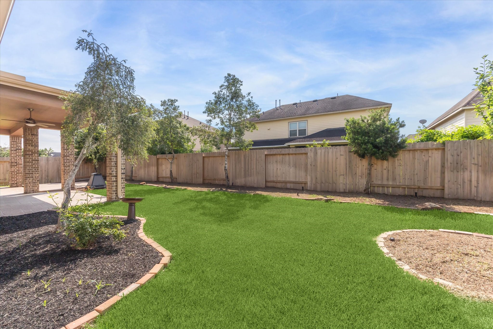 26223 Rustic Ranch Lane Katy, TX 77494 - Photo 29 of 33 a view of a backyard with table and chairs and wooden fence