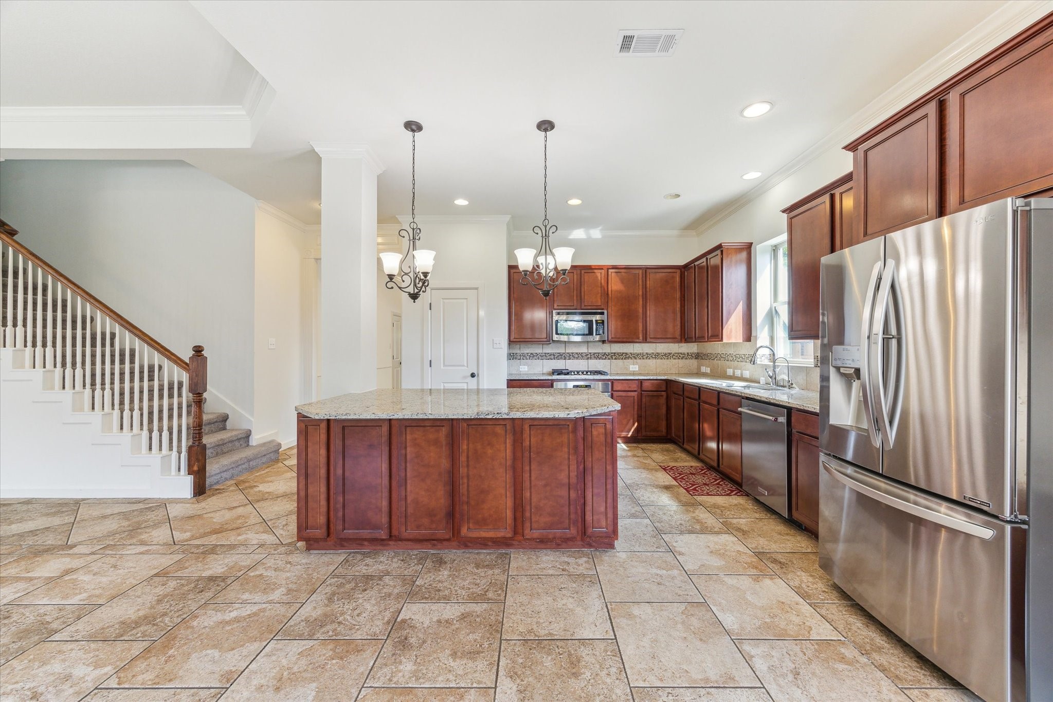26223 Rustic Ranch Lane Katy, TX 77494 - Photo 8 of 33 a large kitchen with stainless steel appliances kitchen island granite countertop a refrigerator a stove a sink and a oven