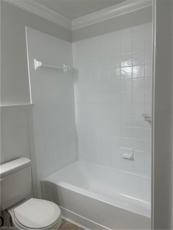 14885 Pleasant Bay Lane, Unit 4104 Naples, FL 34119 - Photo 11 of 17 a bathroom with a toilet and a bath tub
