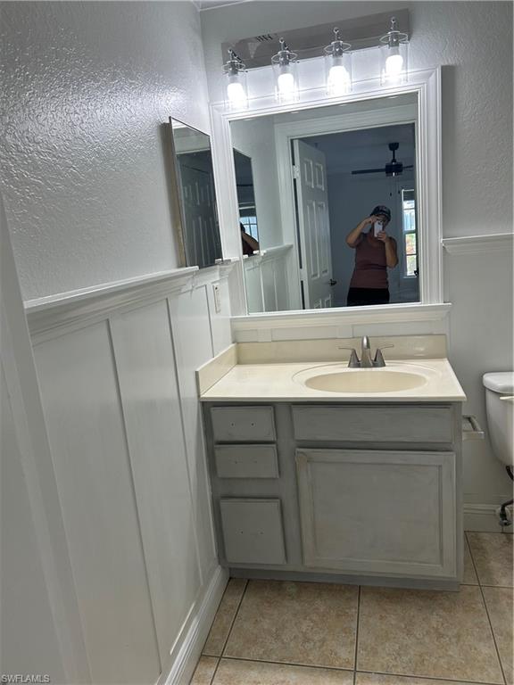 14885 Pleasant Bay Lane, Unit 4104 Naples, FL 34119 - Photo 12 of 17 a bathroom with a sink vanity and mirror
