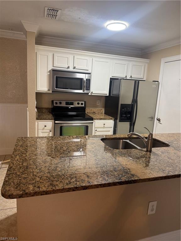 14885 Pleasant Bay Lane, Unit 4104 Naples, FL 34119 - Photo 2 of 17 a kitchen with kitchen island granite countertop a sink cabinets and stainless steel appliances
