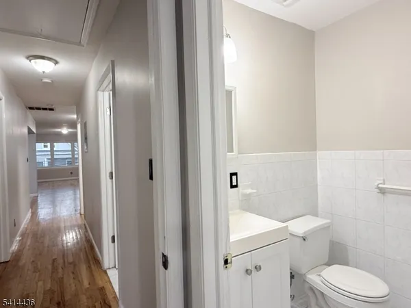 a white toilet sitting next to a bathroom sink