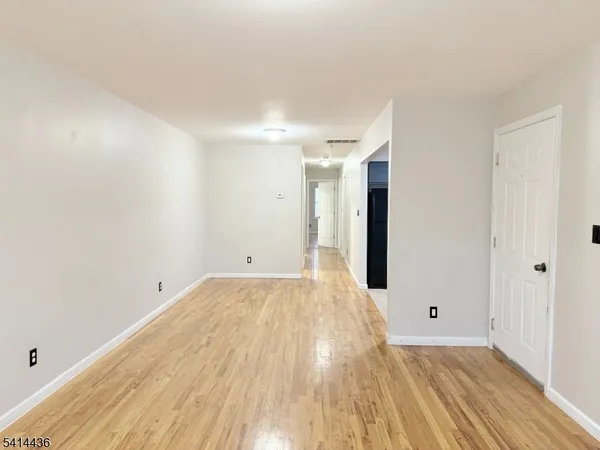a view of a room with wooden floor