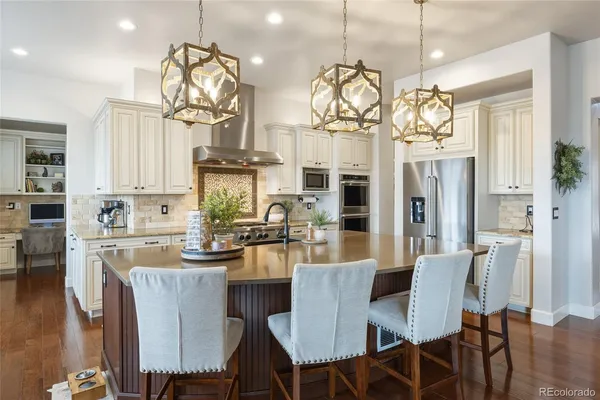 a large kitchen with a table and chairs in it