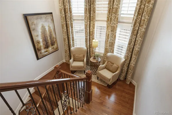 a bedroom with a bed a chandelier and a window