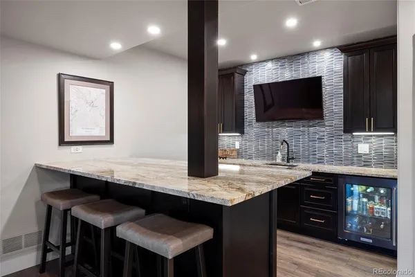 a kitchen with a table chairs sink and cabinets