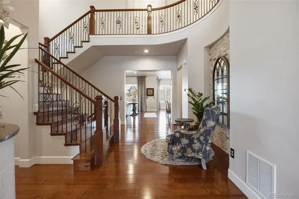 a view of entryway and hall with wooden floor
