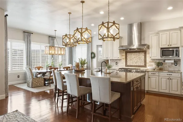 a very nice looking kitchen with granite countertop a large center island attached withe living room