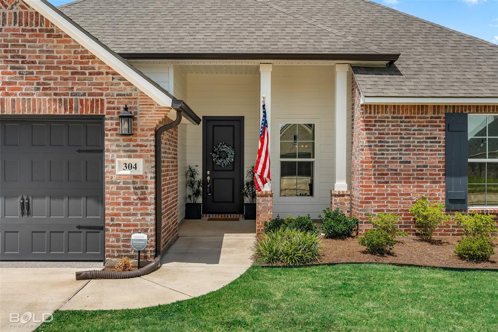 304 Prien Lk Loop Bossier City, LA 71111 - Photo 6 of 39 Brick exterior with a dark gray garage door