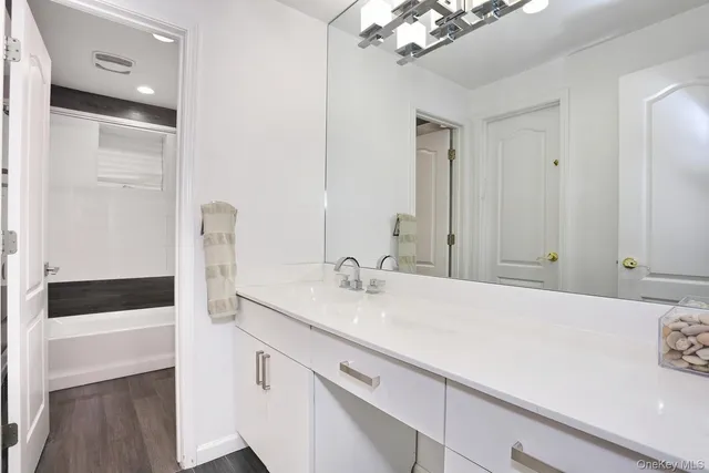 a en suite bathroom with a sink and a mirror