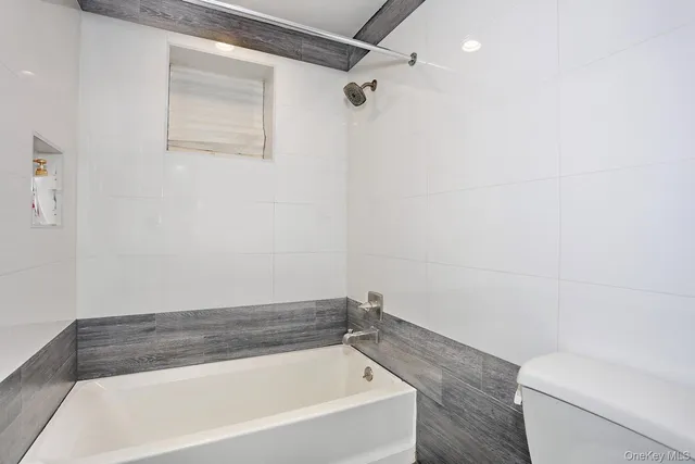 a bathroom with a bathtub and toilet
