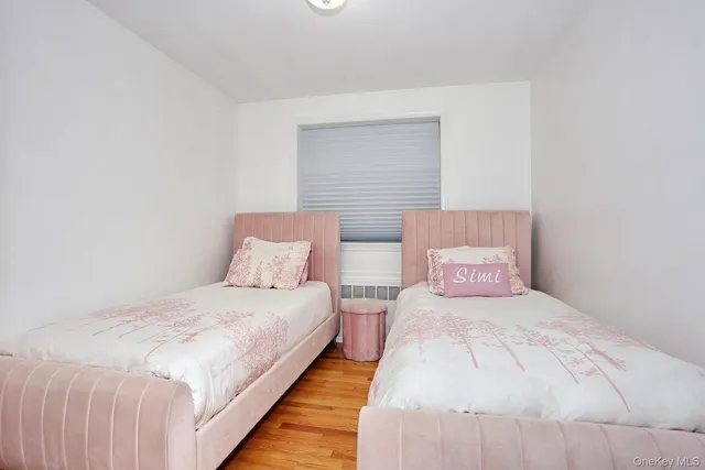 a bedroom with a bed and a night stand