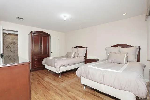 a bedroom with two beds and painting on the wall