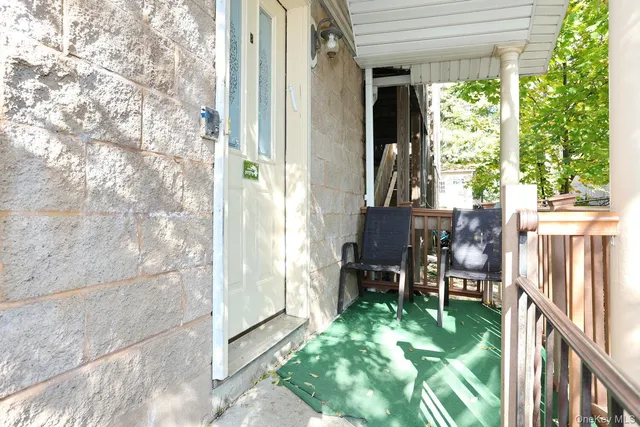 a backyard of a house with yard fountain and outdoor seating