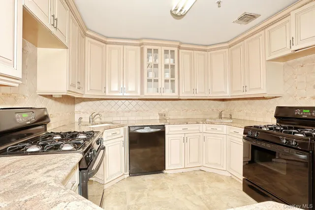 a kitchen with a stove a sink and a window