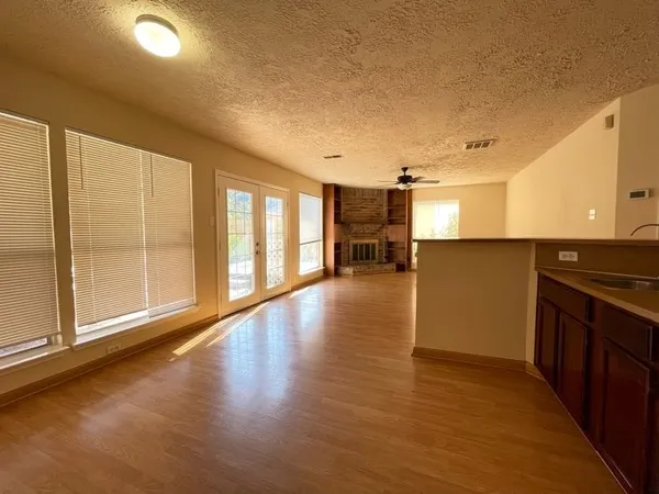 a view of a room with wooden floor and furniture